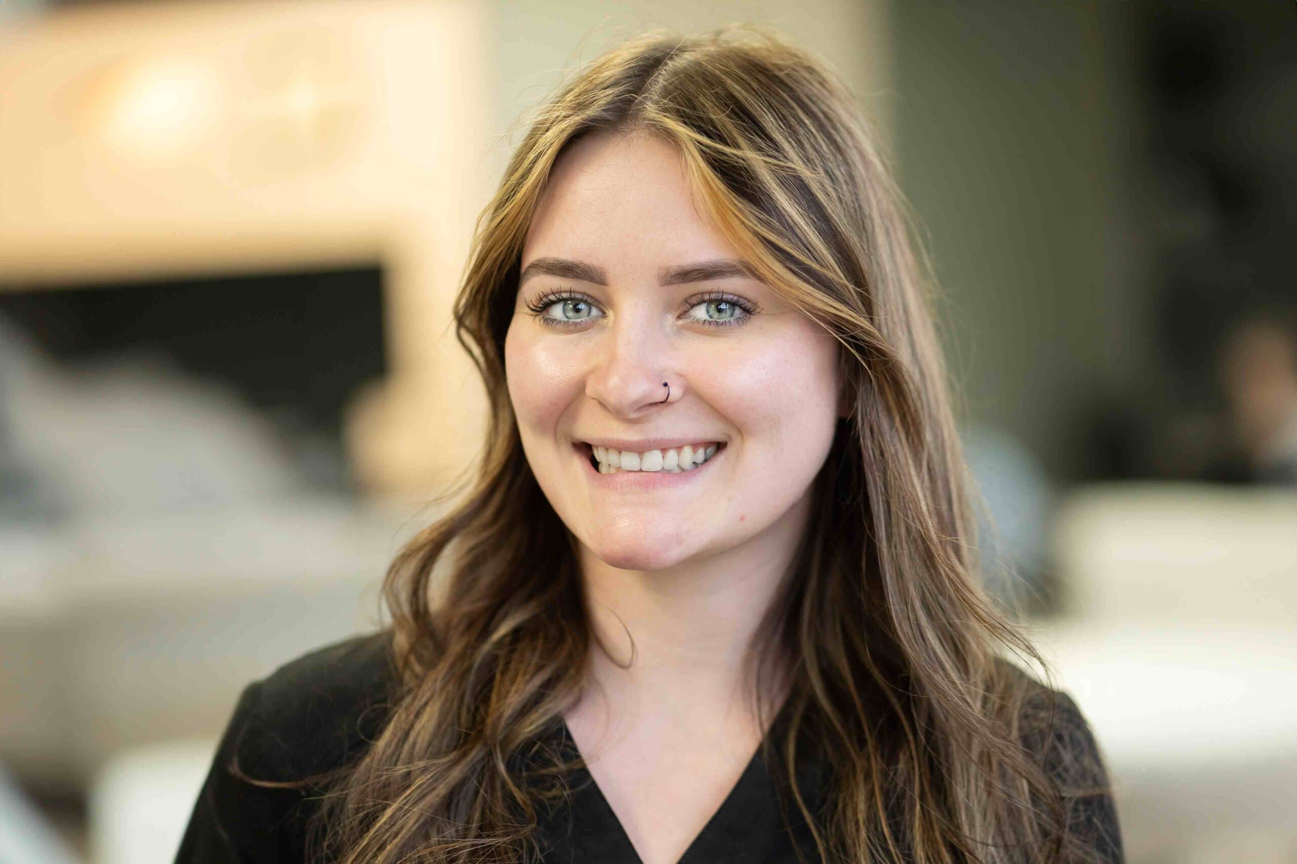 Close up photo of a smiling woman with invisalign.